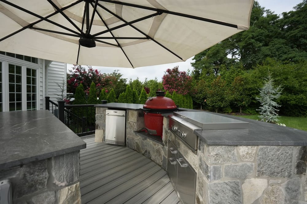 Stone outdoor kitchen with smoker on Trex deck by Deckscapes of Virginia