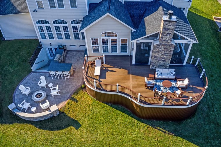 Aerial view deck porch and stone patio with outdoor kitchen