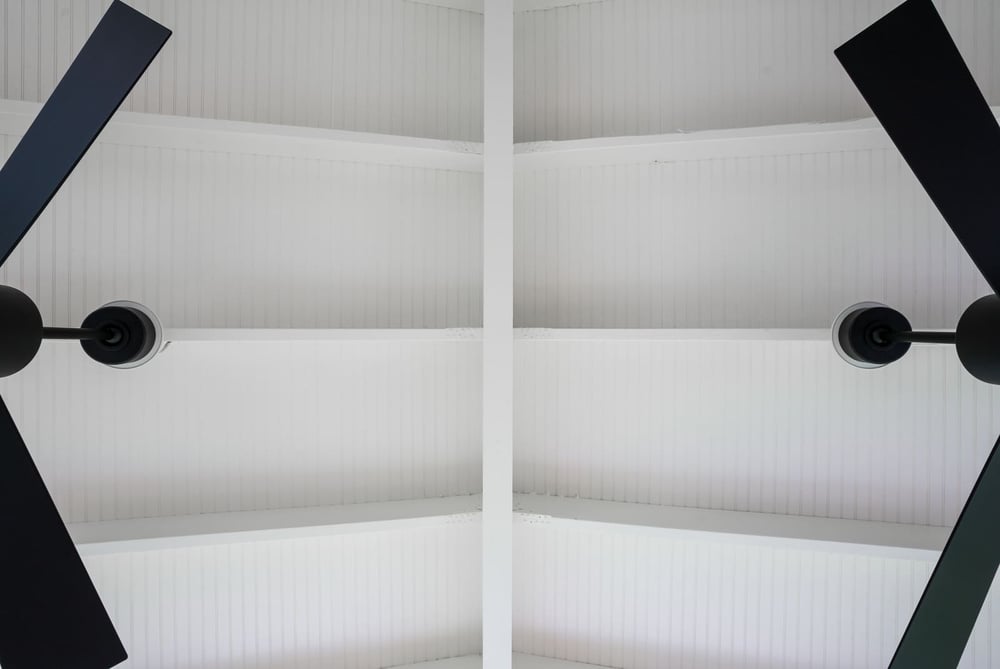 Beadboard vaulted ceiling on porch with two ceiling fans