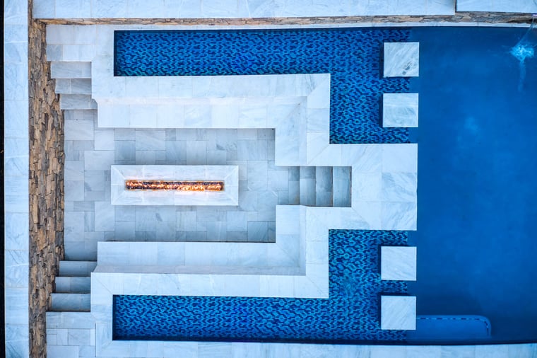 Birds eye view of luxury pool build with fireplace and built-in seating