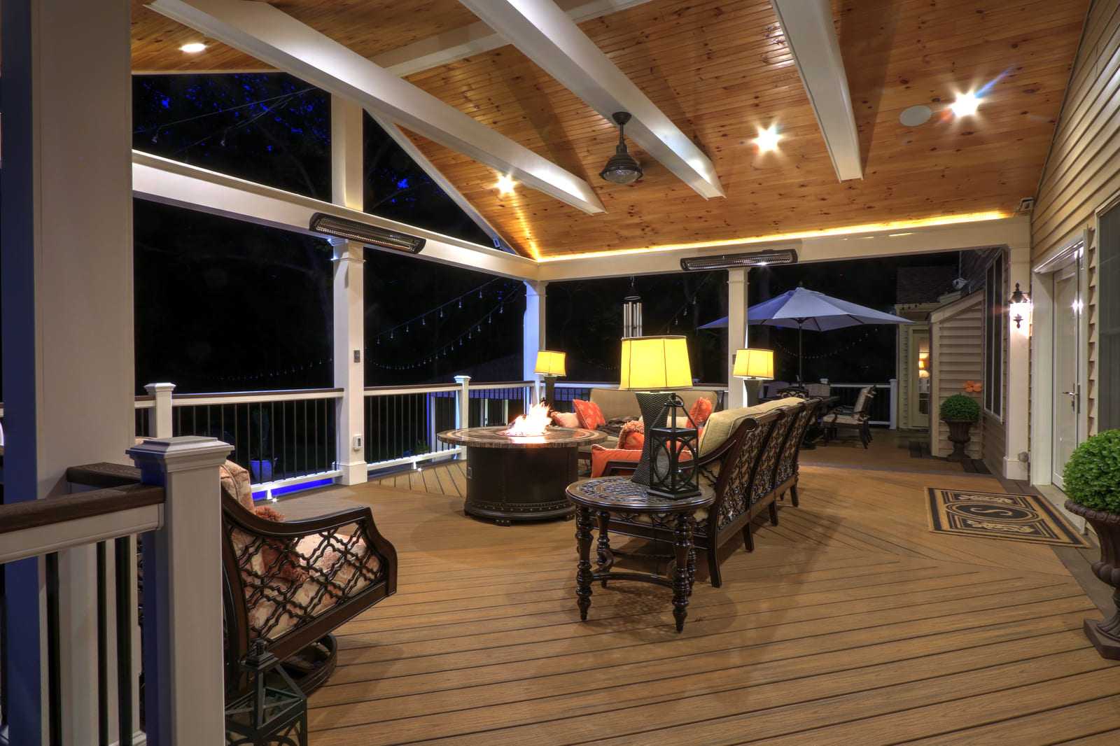 Covered porch interior with recessed lighting in vaulted ceiling at night