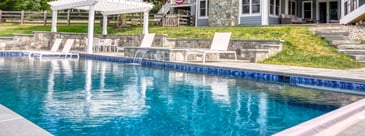 Custom high end in-ground pool with pergola and waterfall feature