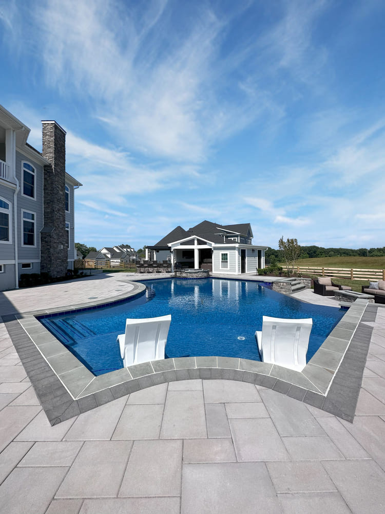 Custom in-ground pool with flagstone patio surrounding