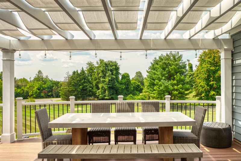 Custom pergola built on deck with dining table underneath