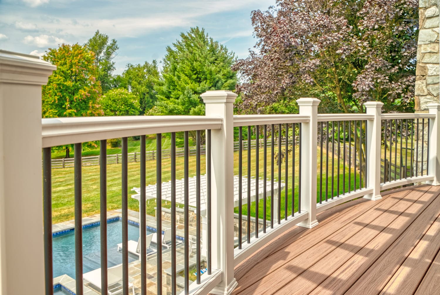 Custom raised deck railing with white posts in Northern Virginia