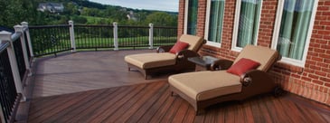 Custom raised deck with chevron pattern decking and two chairs