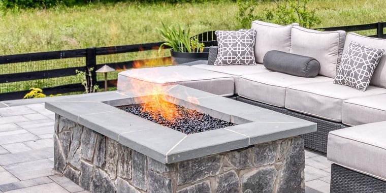 Custom stone fireplace on patio with outdoor furniture