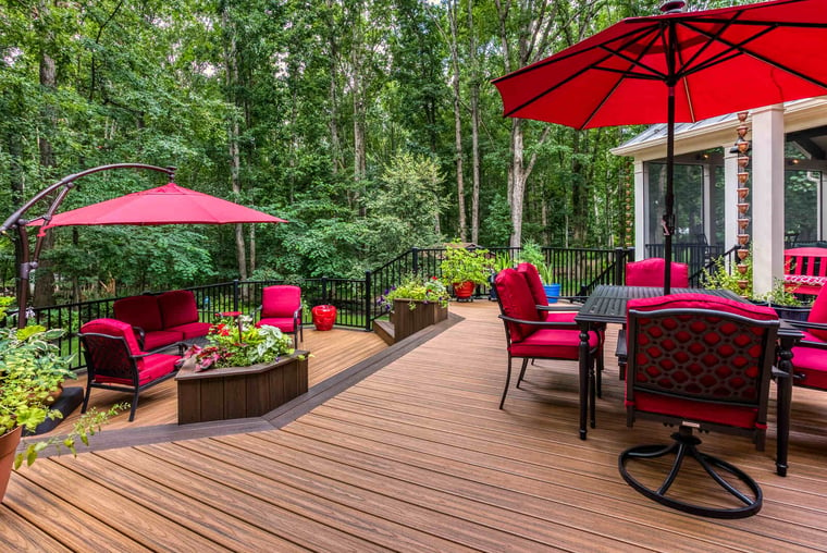 deck with lounge furniture and two umbrellas