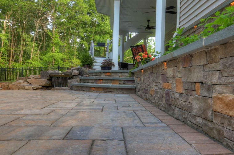 Flagstone patio material close up with retaining wall