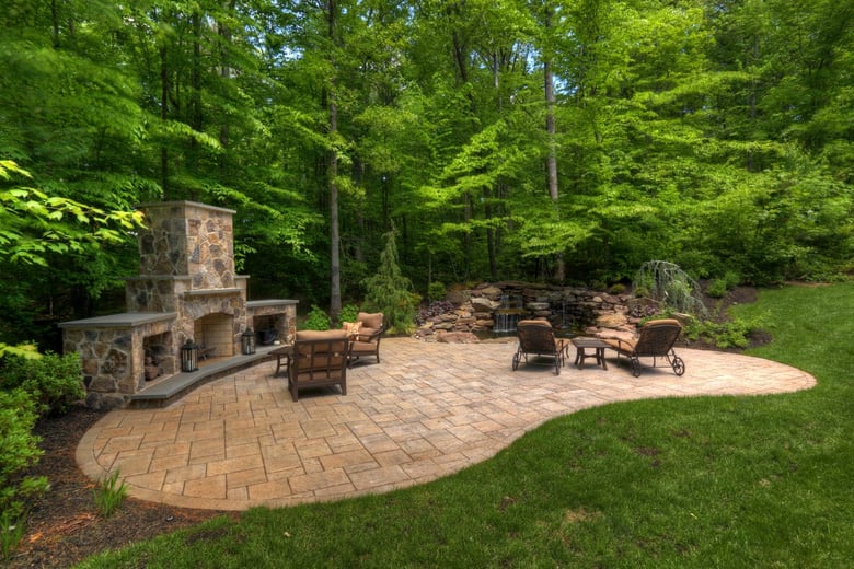 Flagstone patio with large fireplace and log storage