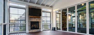 Interior of custom porch with stone fire place and vaulted ceiling