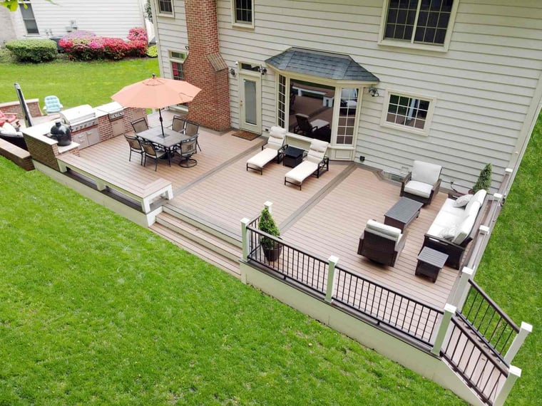 Large deck with custom outdoor kitchen with brick detailing