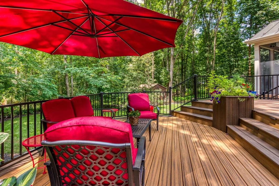 Lower deck level in backyard with outdoor furniture