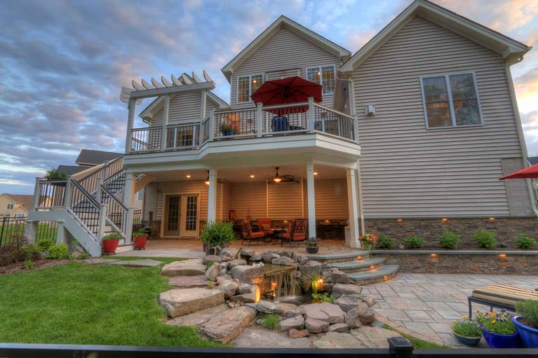 Luxury paver patio with stone walkway and waterfall