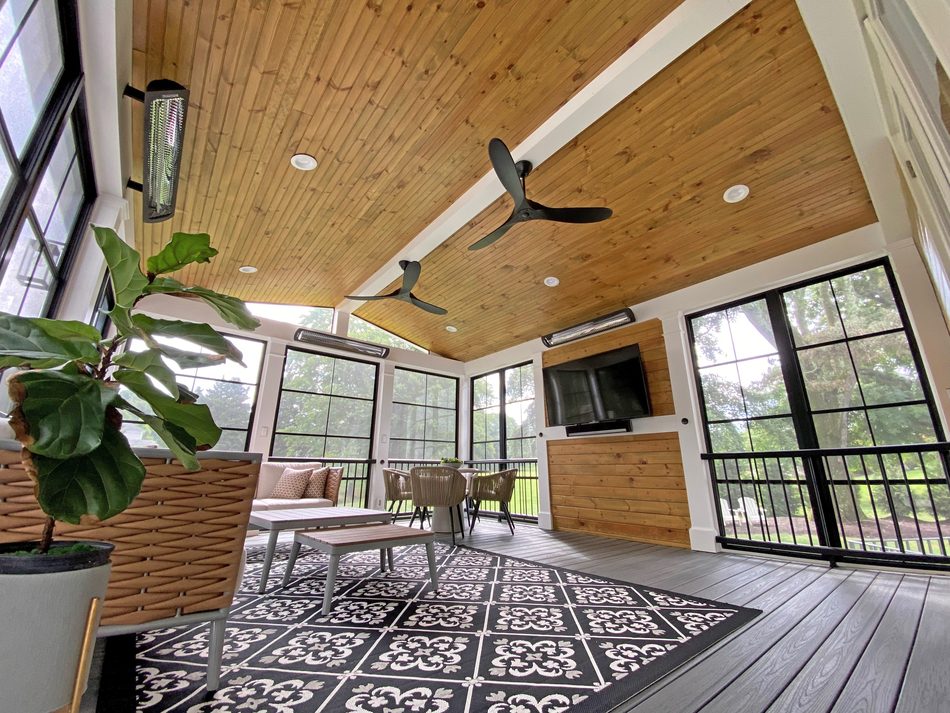 Modern porch interior with black framed screens and mounted TV