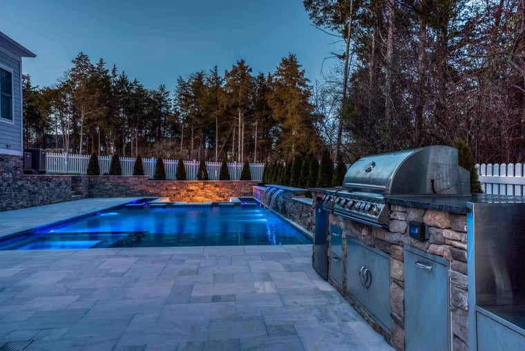 Outdoor Backyard With Stone Pool and Waterfall With Custom Lighting