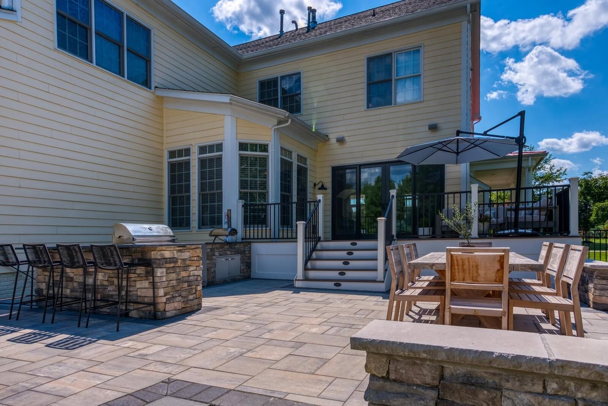 outdoor stone patio with table and bar seating in northern virginia