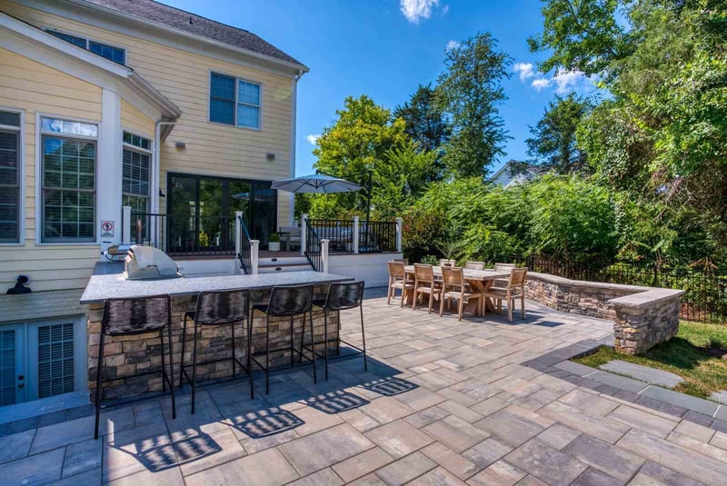 Outdoor patio area with built-in kitchen and seating