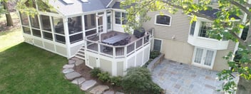 Paver patio, screened-in porch, and raised deck