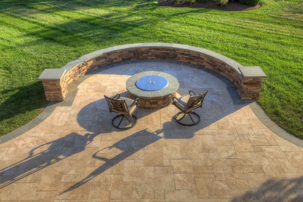 Paver patio with curved seating wall and custom fire pit