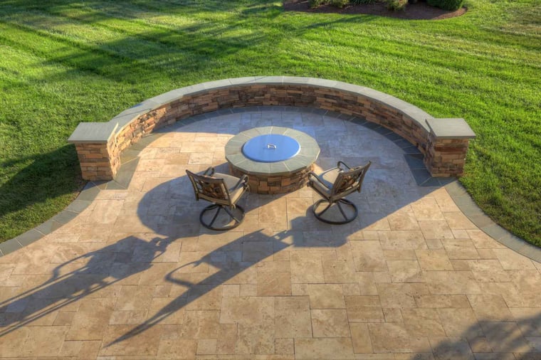 Paver patio with curved seating wall and custom fire pit