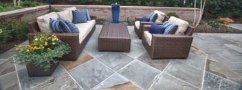 Paver patio with furniture and angled wall