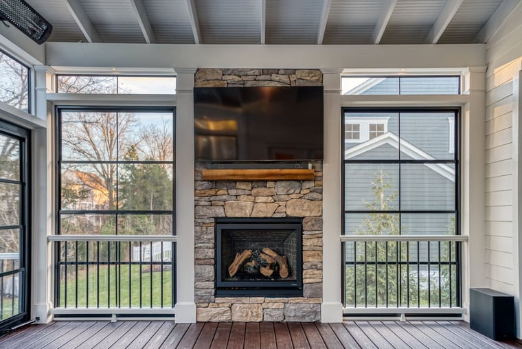 Porch interior with built-in fireplace and black railing