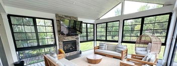 screened in porch with wall mounted tv and furniture in Virginia