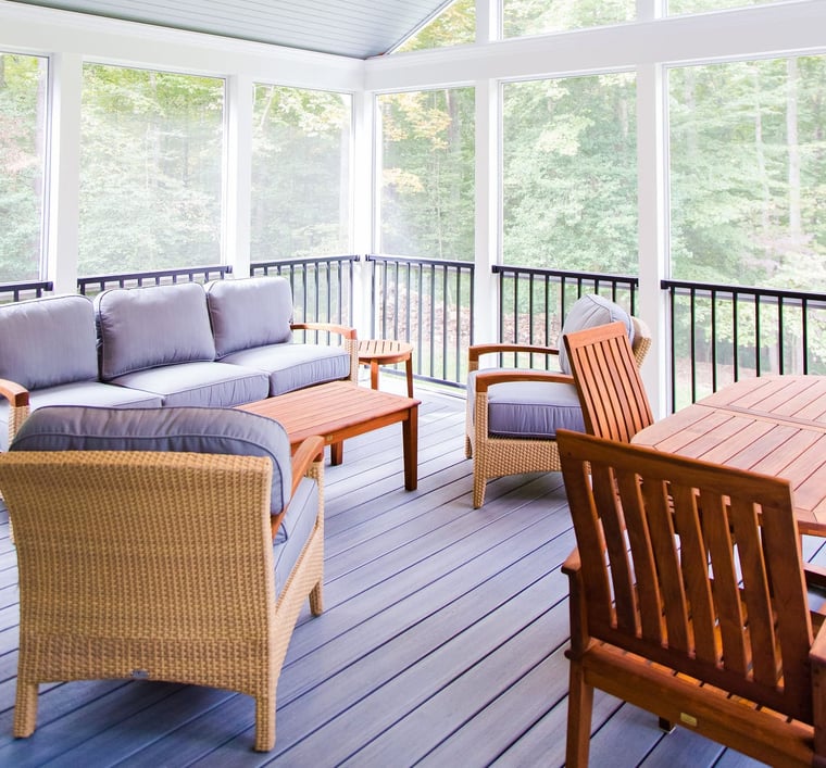 Screened-in porch interior with black railing and white framing