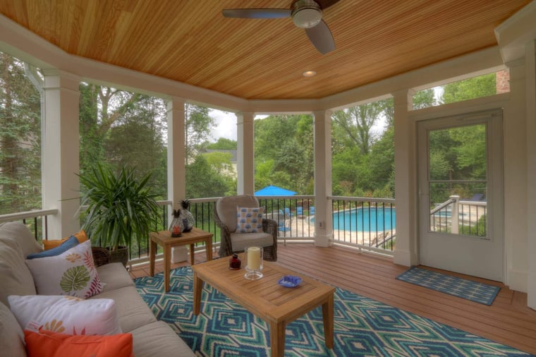 Screened-in porch interior with furniture and recessed lighting