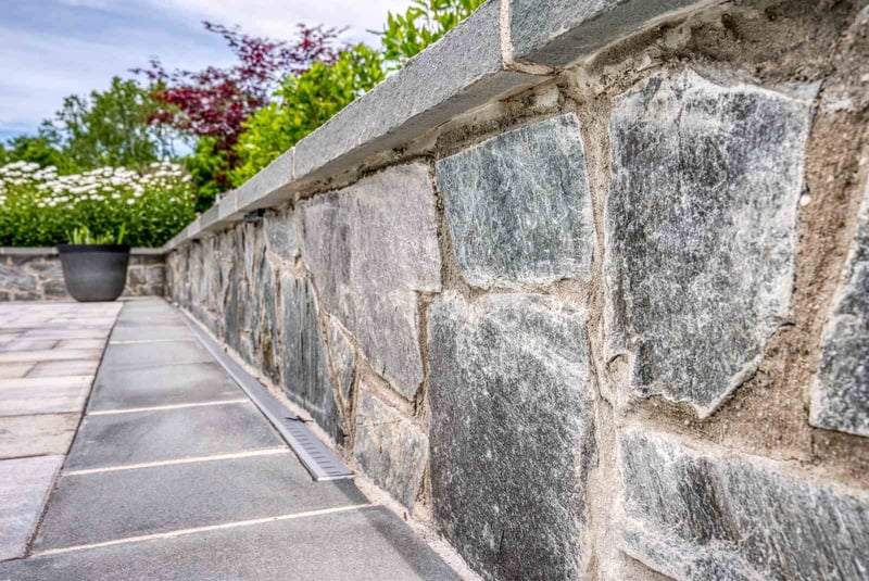 Stone material in retaining wall on custom-built patio