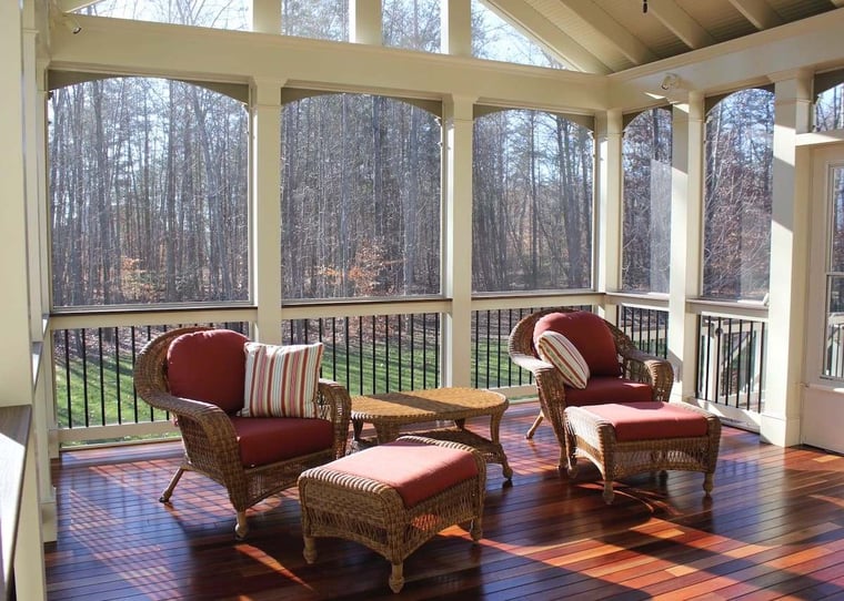 Two chairs in screened porch with vaulted ceilings and floor to ceiling windows