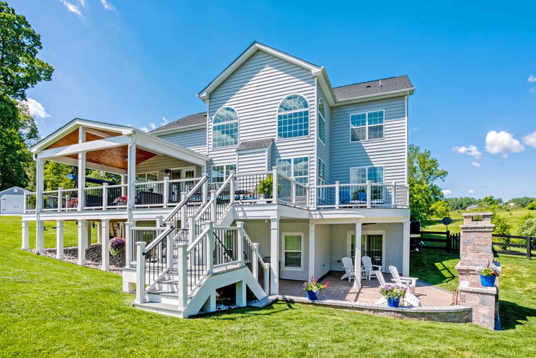 two-story deck in Northern VA with white rail posts and patio