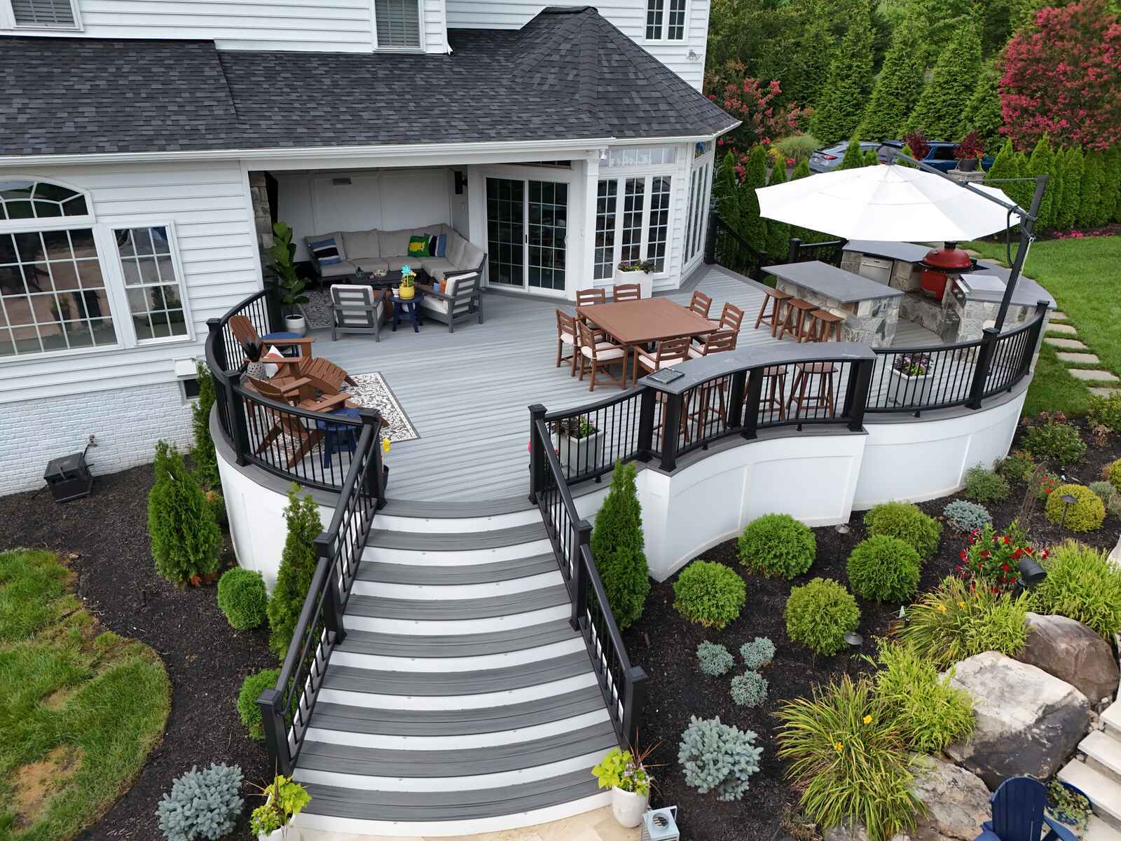 Beautiful multi-level deck with dining, lounging, and barbecue area, designed by Deckscapes of Virginia