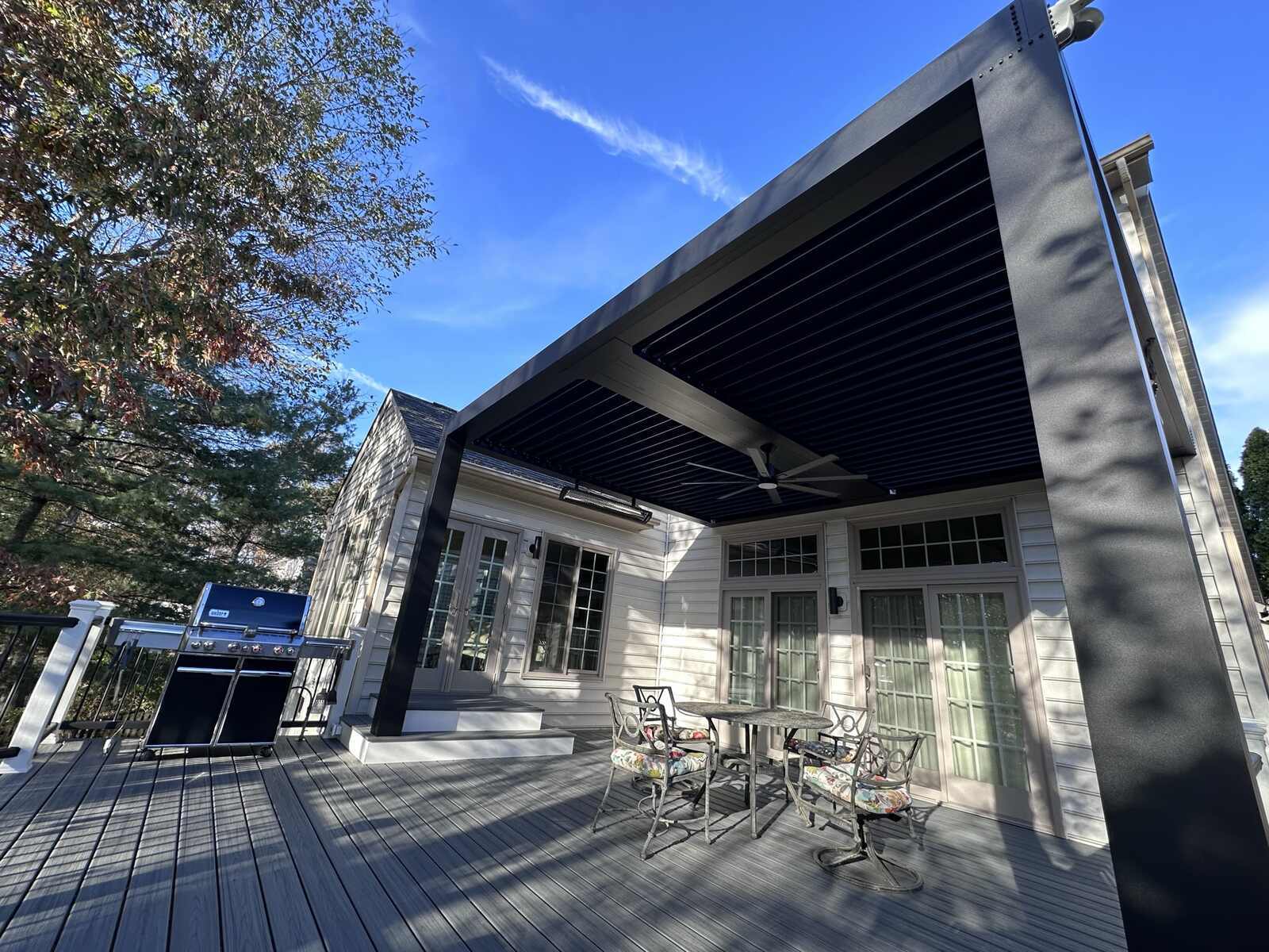 Custom StruXure pergola providing shade on a backyard deck by Deckscapes of Virginia in Northern Virginia