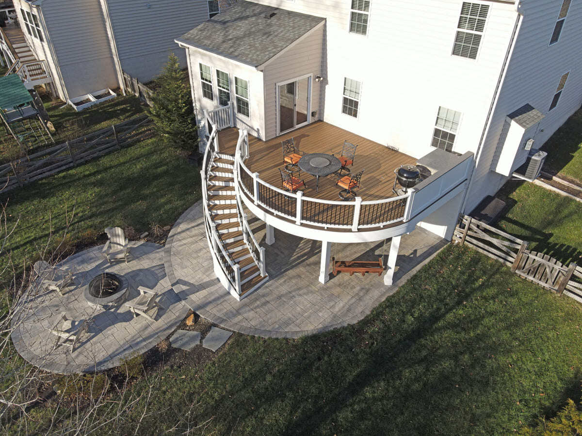 Drone view of raised curved deck and patio by Deckscapes of VA