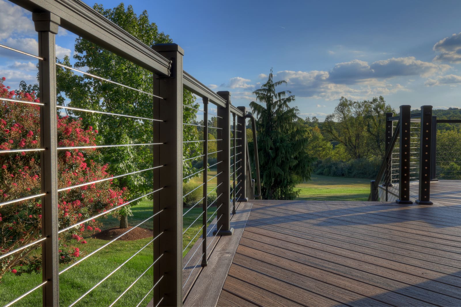 Cable railing on two-story composite deck by Deckscapes of Virginia