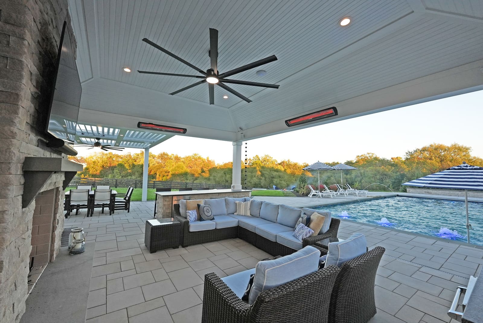 Covered outdoor patio with Bromic heaters by Deckscapes of Virginia