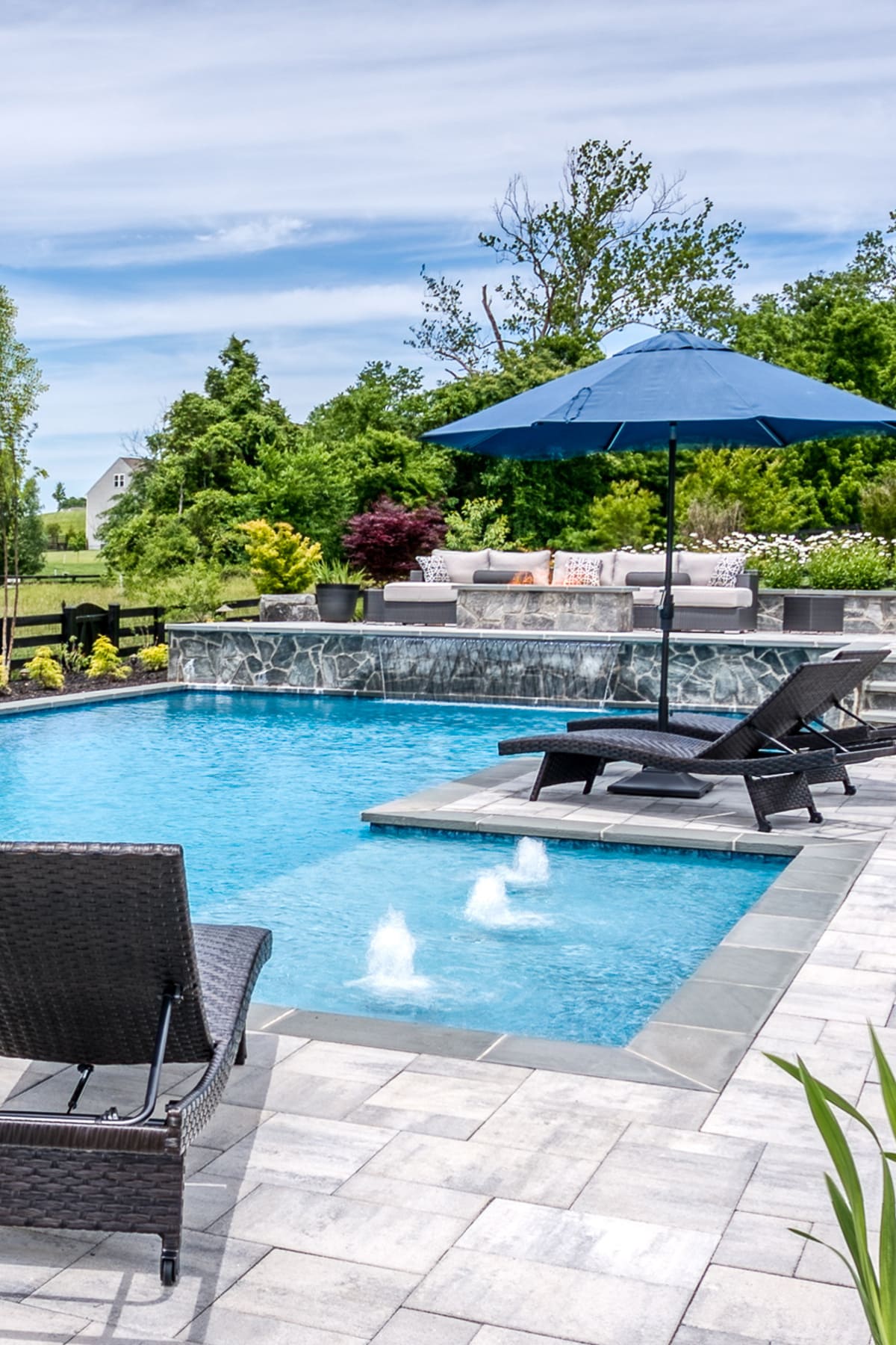 Gunite pool with water feature by Deckscapes of VA