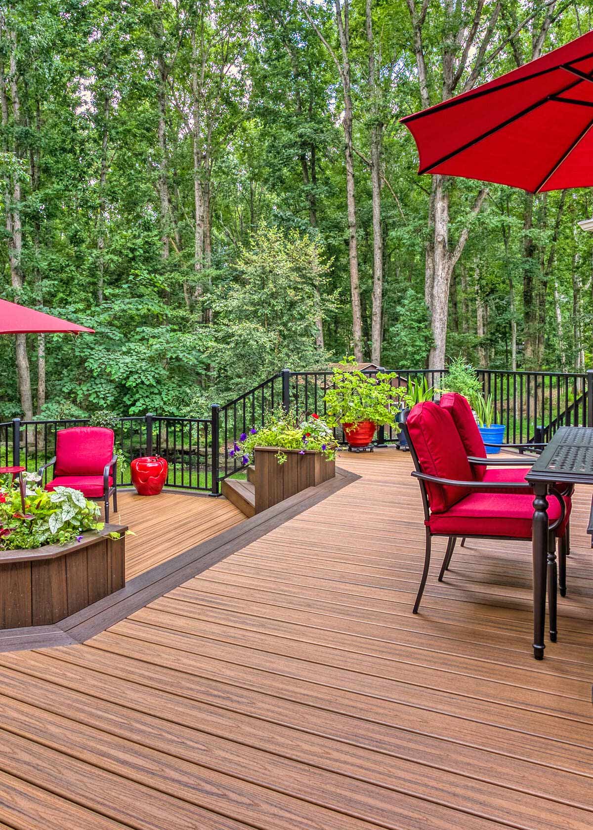 Potted plants and furniture on multi-level deck design by Deckscapes of Virginia