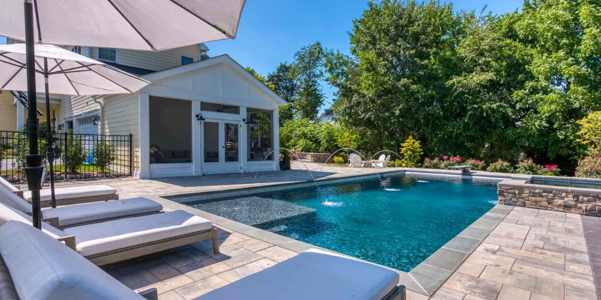 Backyard lounge chairs with in-ground pool