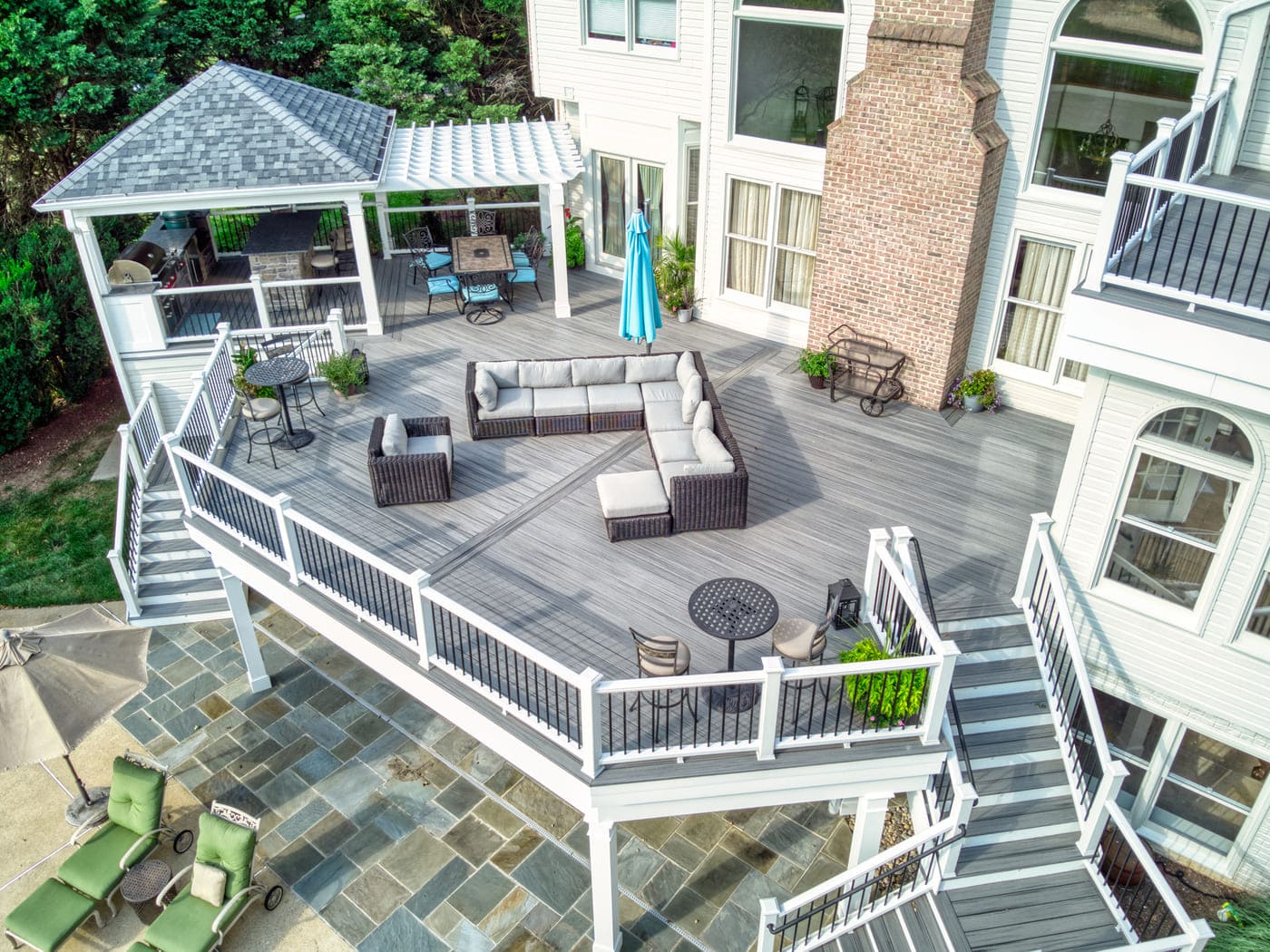 expansive second story deck with white posts and attached pergola